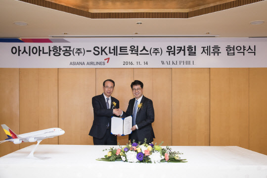 14일 서울 광진구 워커힐 호텔 애스톤 하우스에서 조규영 아시아나항공 부사장(왼쪽)과 박상규 SK네트웍스 워커힐 총괄이 제휴 협약을 맺은 후 기념촬영을 하고 있다.<아시아나항공 제공>